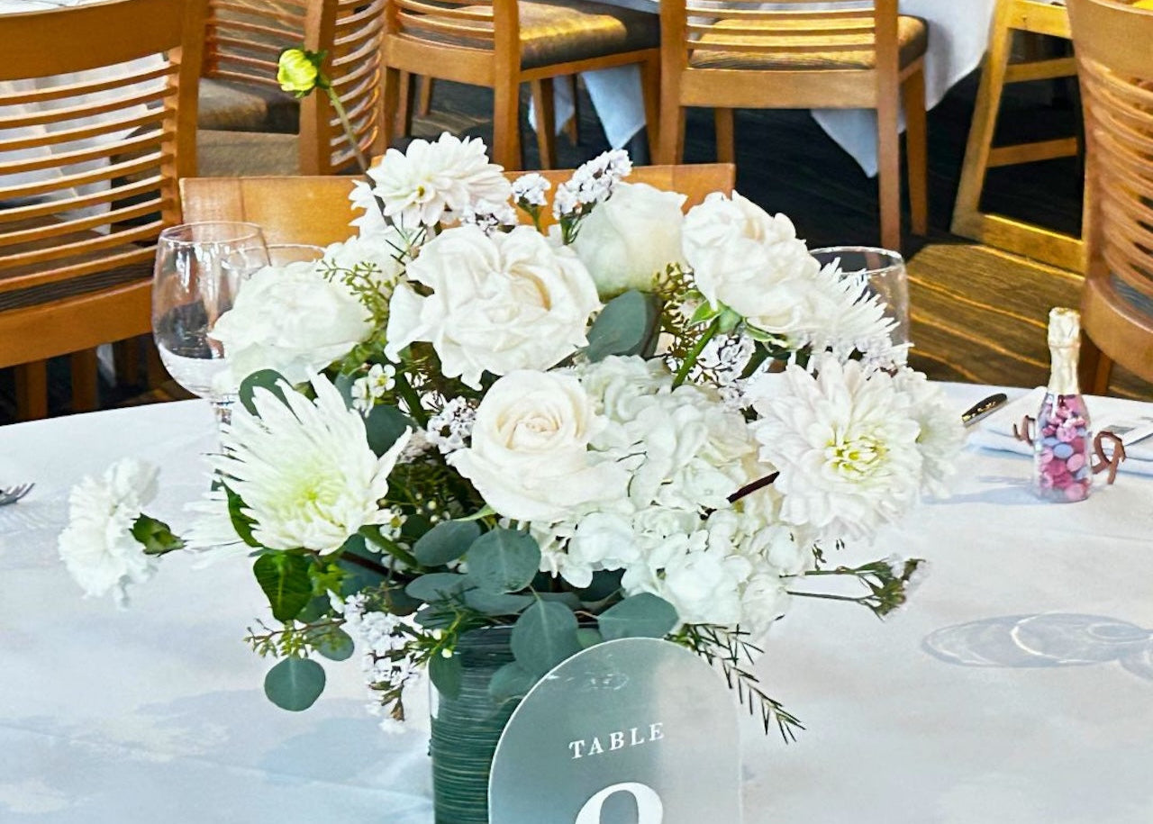 elegant wedding reception centerpiece in glass vase arrangement