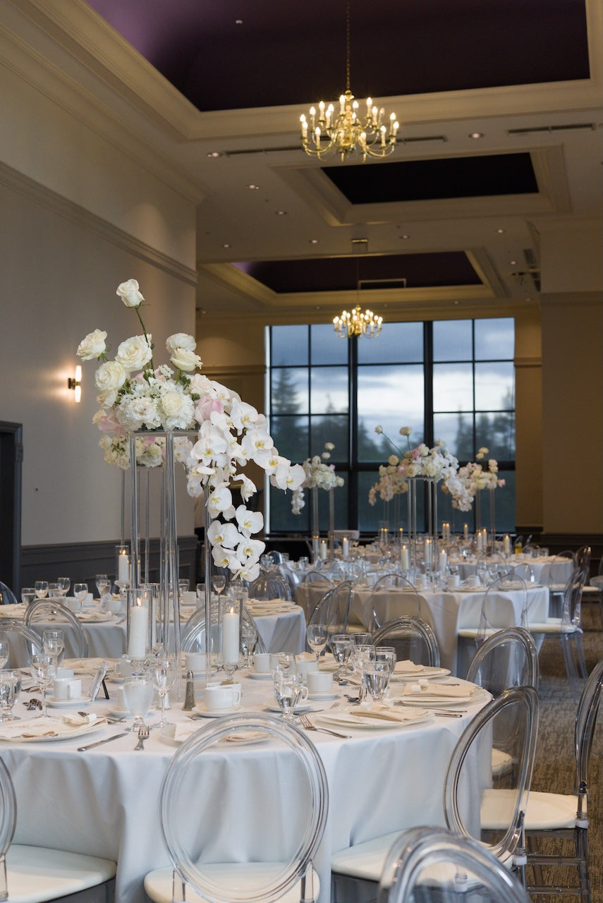Decorated event space with tables, chairs, and orchard floral centerpieces at Swaneset Bay Resort & Country Club grand ball room.