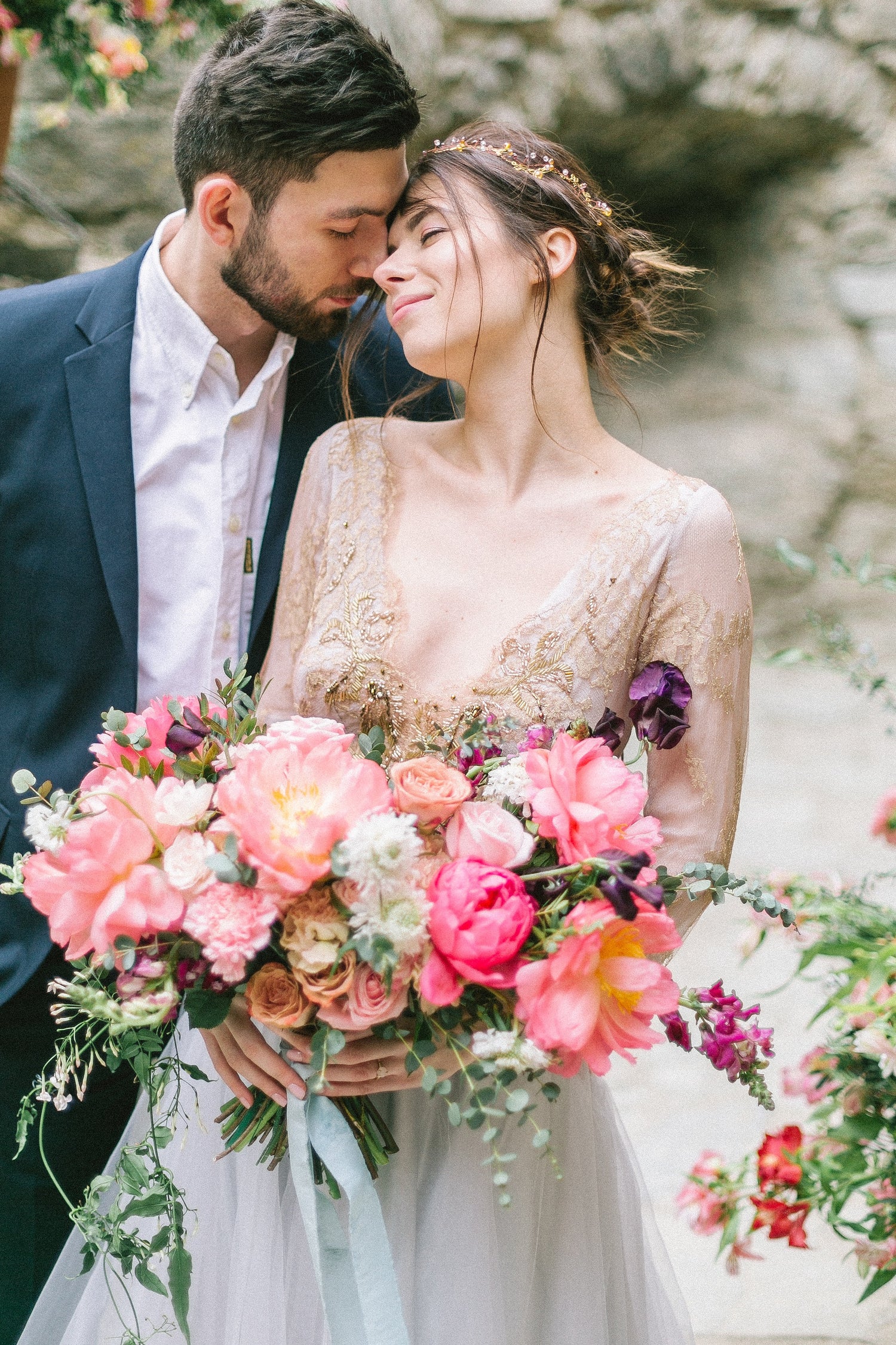 Young couple holding a  luxurious bridal bouquets of flowers