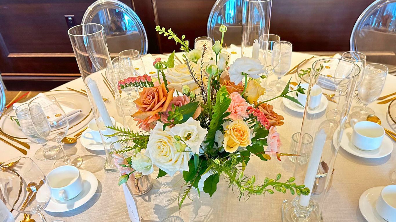 Terminal City Club wedding reception, table setting with floral centerpiece, candles, and fine china.