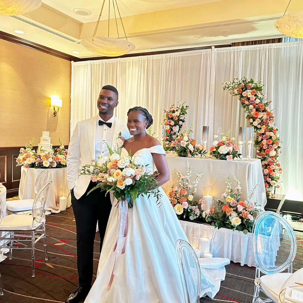 Vancouver bride and groom in formal attire standing in a decorated wedding reception room at Terminal City Club with floral arrangements.