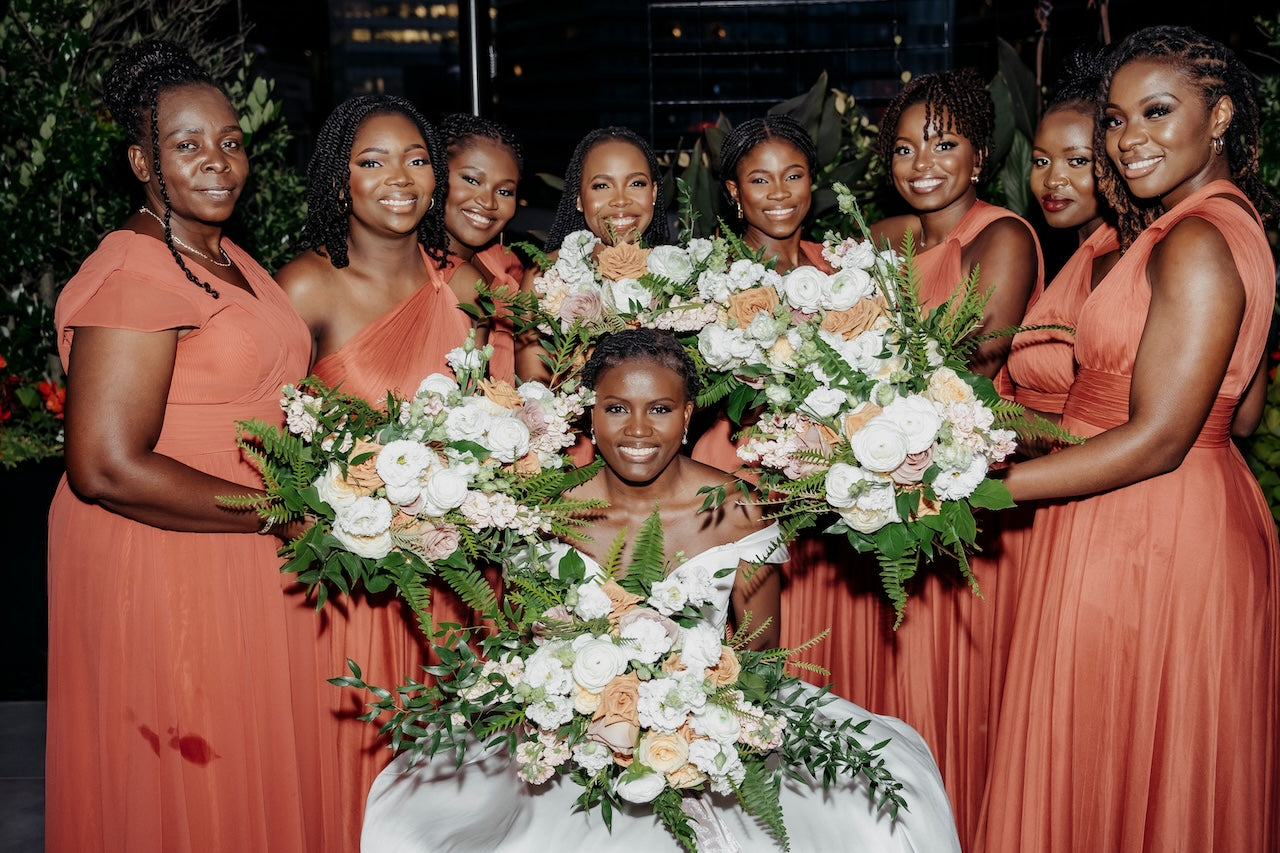 Vancouver Bride with bridesmaids holding floral bouquets in a celebratory setting