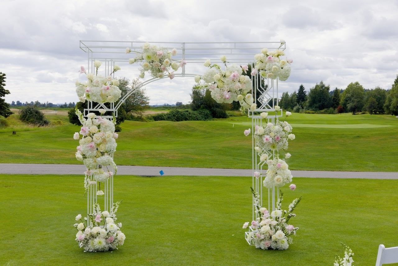 Floral archway at Swaneset Bay Resort & Country Club field with trees in the background
