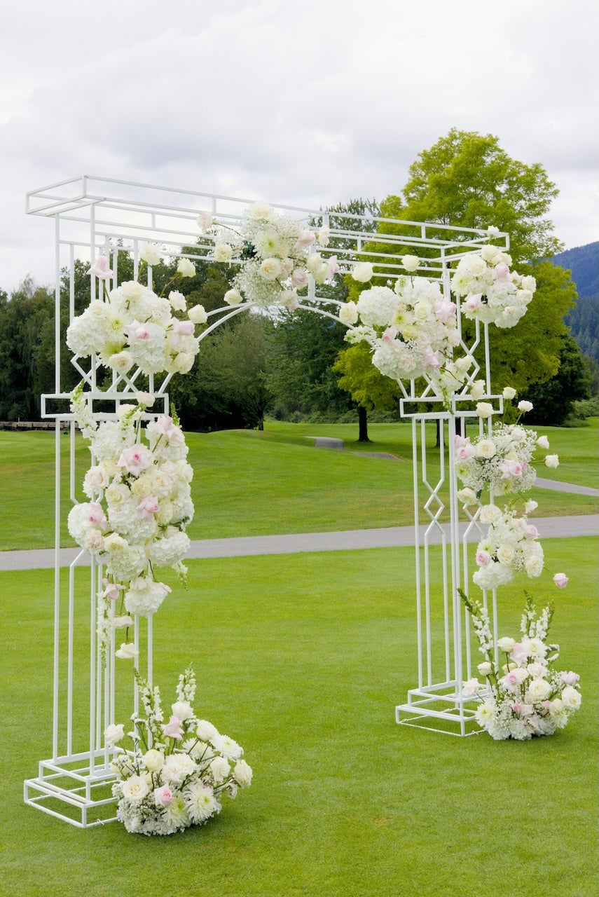 Decorative floral arch with white and pink flowers at Swaneset Bay Resort & Country Club outdoor setting