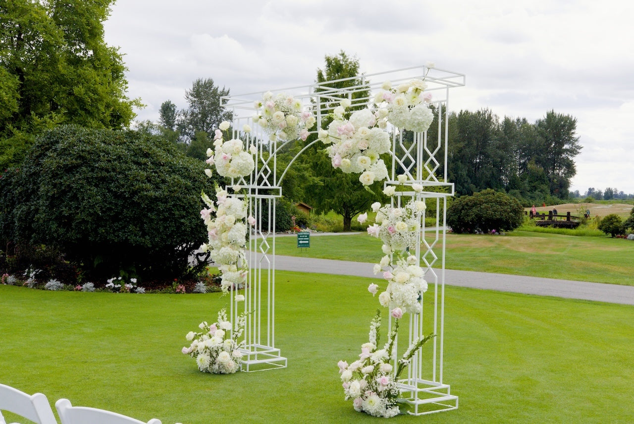 Decorative floral archway at Swaneset Bay Resort & Country Club field with trees in the background