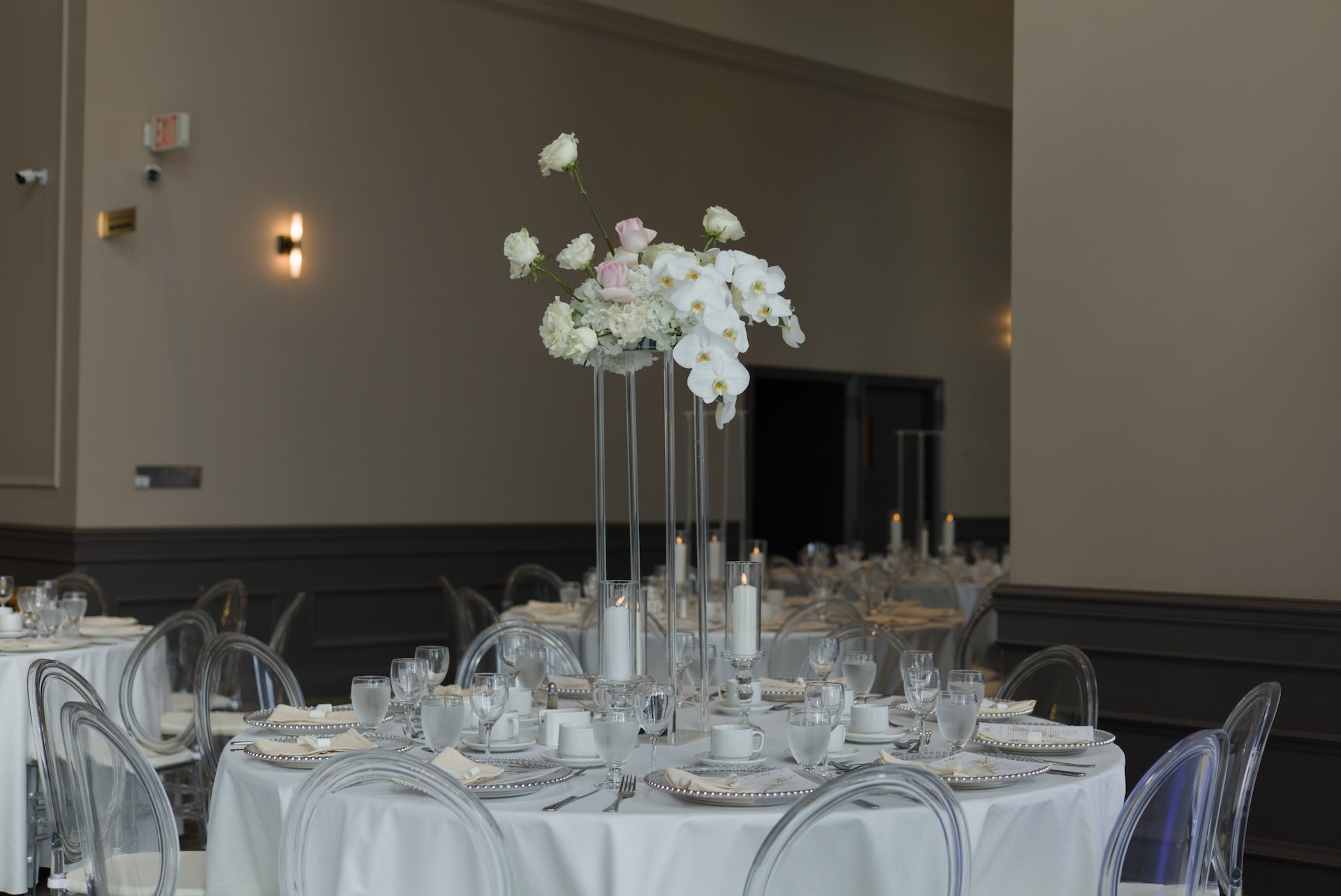 Swaneset Bay Resort & Country Club grand ball room tables set for a wedding reception, featuring a orchard floral centerpiece.