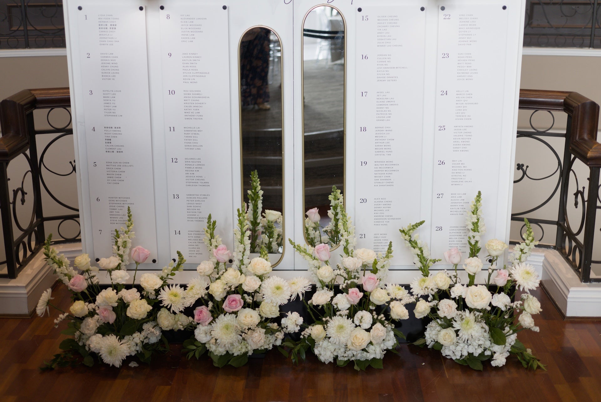 Floral arrangements in front of a seating chart at Swaneset Bay Resort & Country Club.