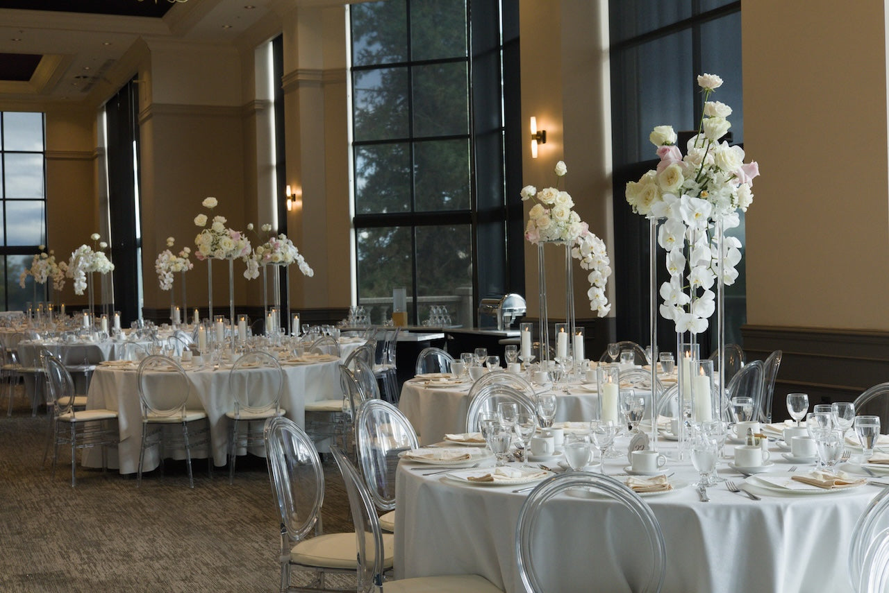 Decorated banquet hall with orchard floral arrangements set for a wedding at Swaneset Bay Resort & Country Club grand ball room.