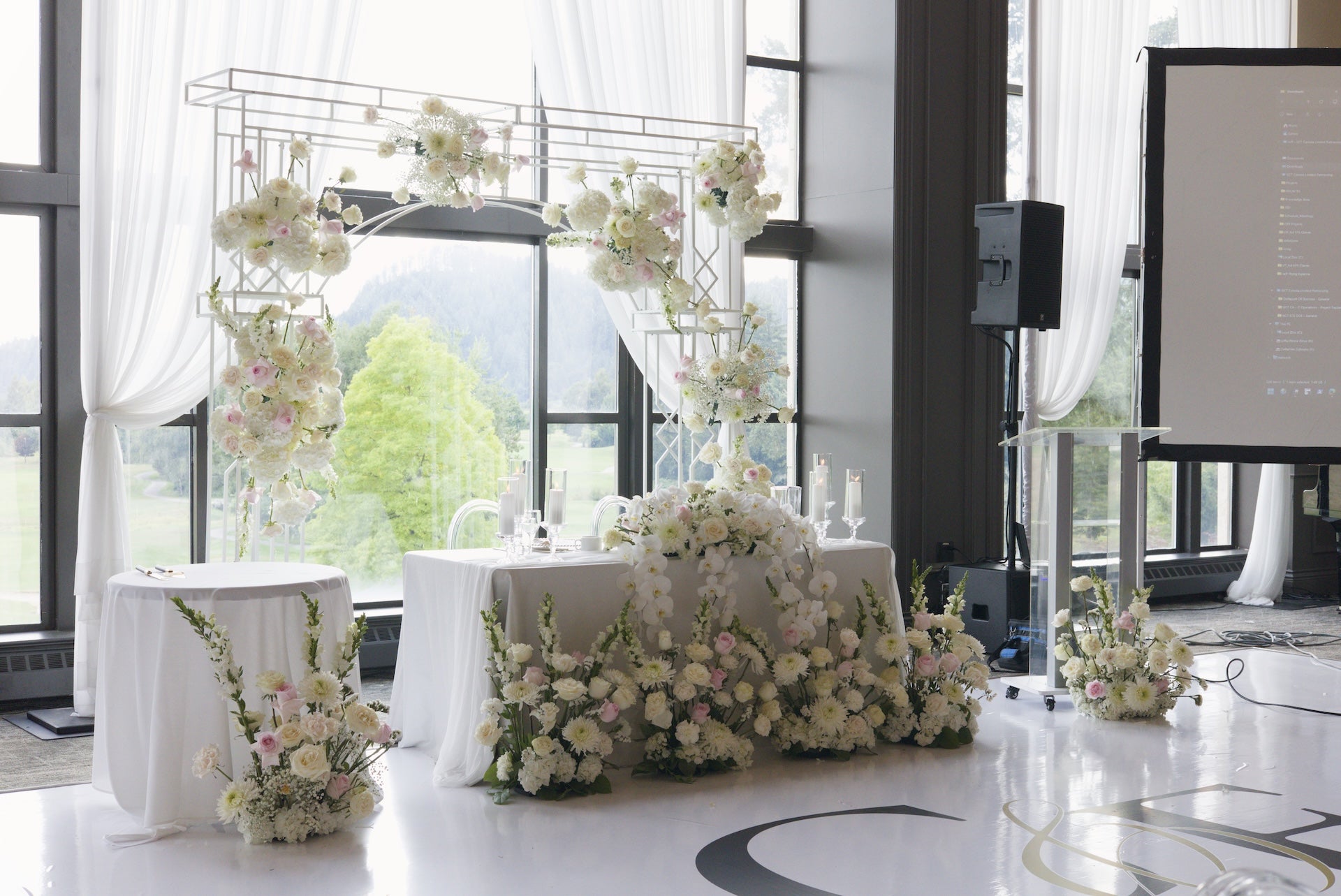 Decorative floral arch, head table arrangements in  Swaneset Bay Resort & Country Club grand ballroom.