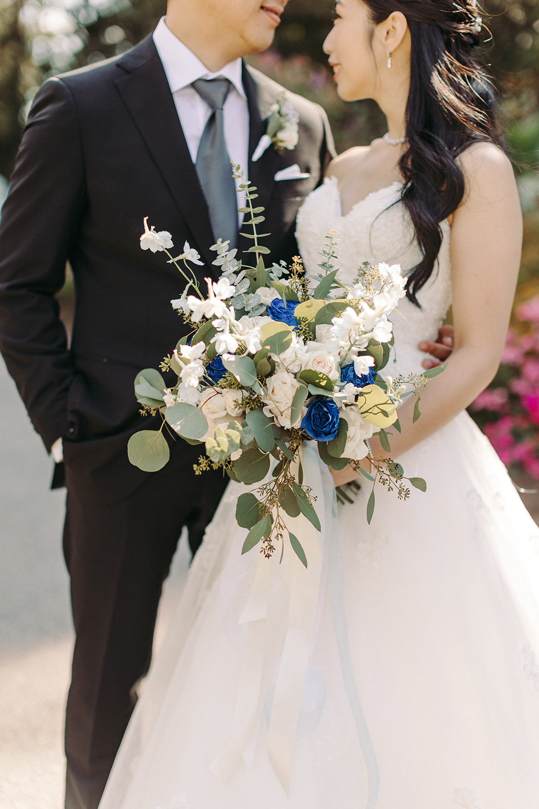 Couple holding a bouquet of flowers with a blurred background