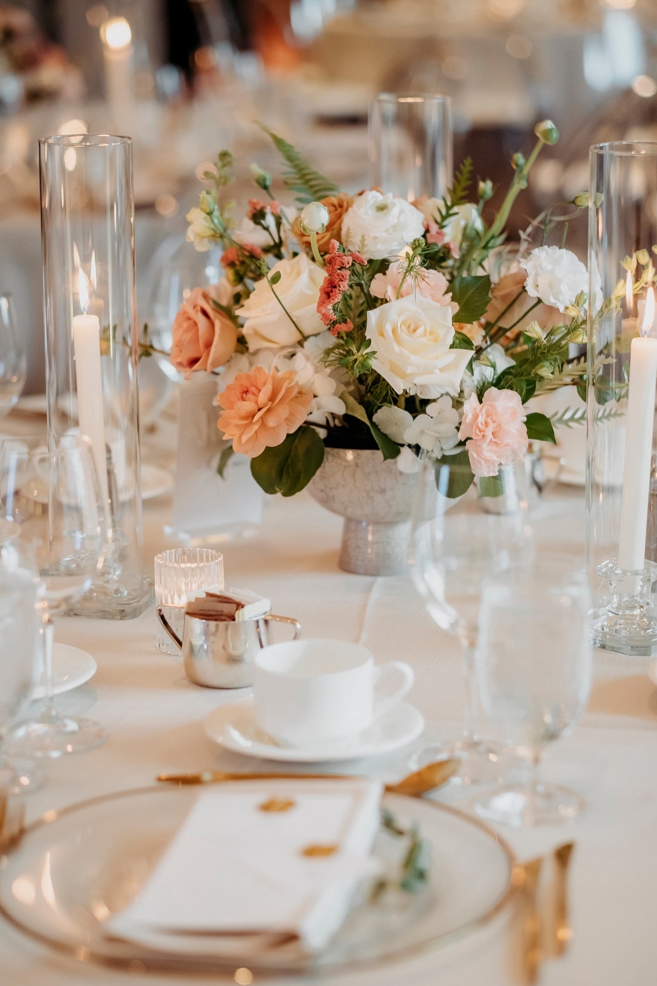 Terminal City Club wedding reception, table setting with floral centerpiece, candles, and fine china.