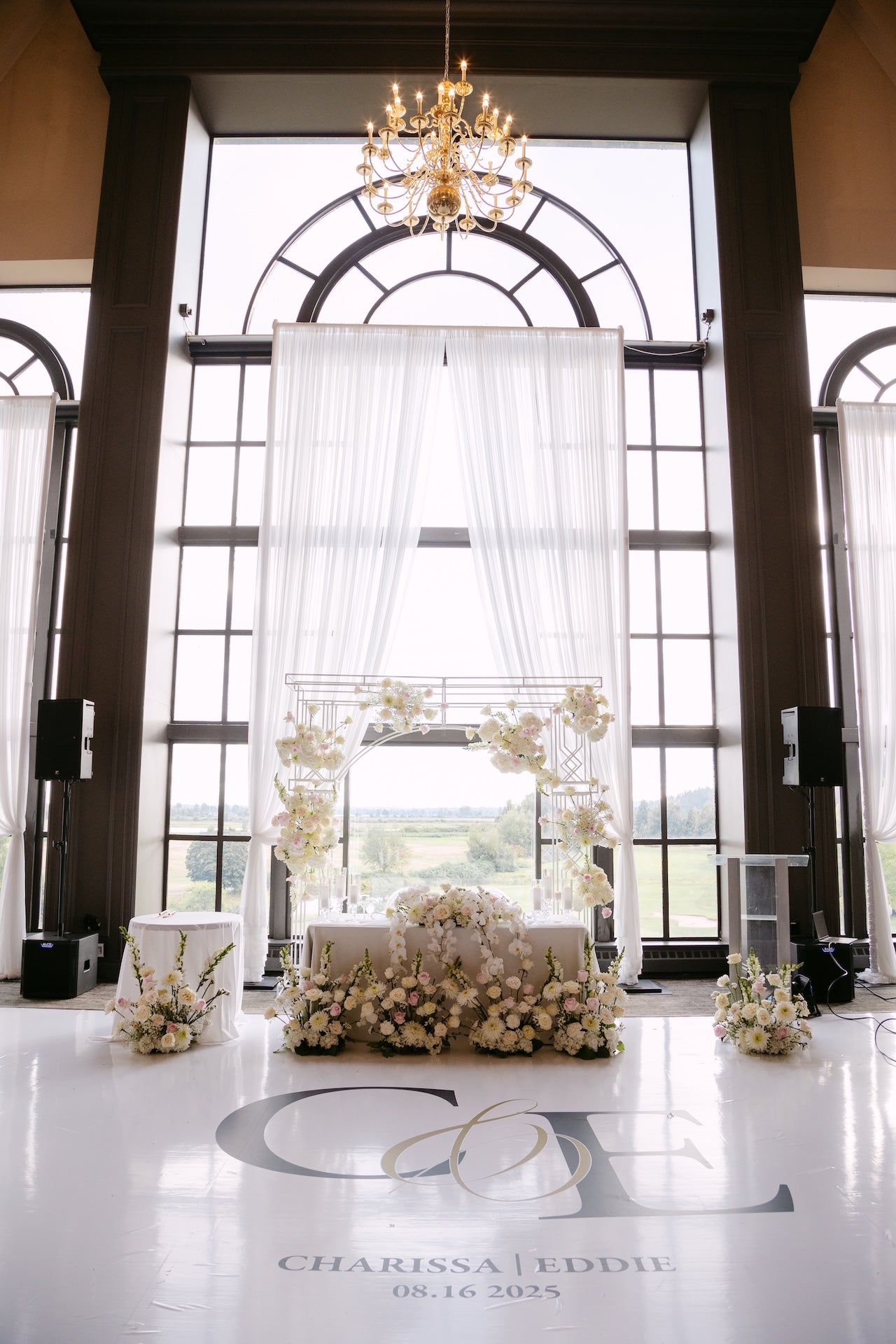 luxury wedding head table floral arrangement with floral arch in Vancouver