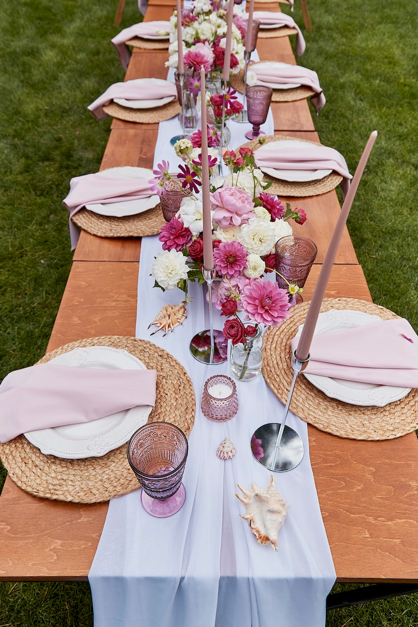 Low lash floral centrepieces for wedding with candles.